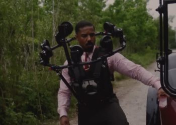 Warner Bros. Pictures reveals how twin scenes in Sinners were filmed using the innovative Halo Rig—featuring 10–12 cameras to capture Michael B. Jordan’s face and map it onto a stunt double in 50% of twin appearances.