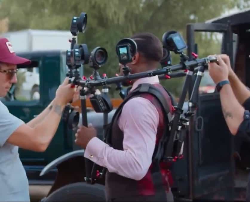 Warner Bros. Pictures reveals how twin scenes in Sinners were filmed using the innovative Halo Rig—featuring 10–12 cameras to capture Michael B. Jordan’s face and map it onto a stunt double in 50% of twin appearances.