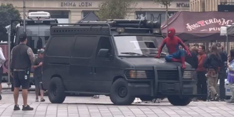 The first look at Tom Holland’s Spider-Man atop the Punisher van on the set of Marvel’s Spider-Man: Brand New Day in Glasgow, Scotland has been revealed.
