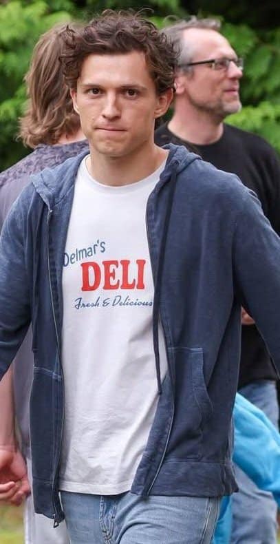 New set images from Marvel's Spider-Man: Brand New Day show Tom Holland's Peter Parker delivering flowers to Aunt May’s grave, filmed at Brookwood Cemetery in Surrey, London.