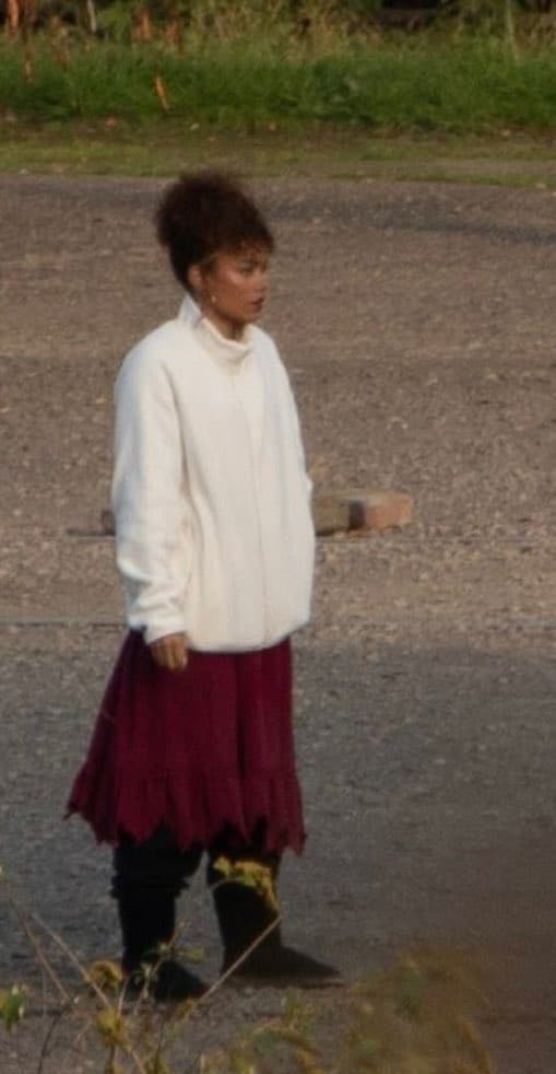 New set images from The Hunger Games: Sunrise on the Reaping reveal Whitney Peak as Lenore Dove and Scot Greenan as Burdock Everdeen, spotted filming between takes at Landschaftspark in Germany.