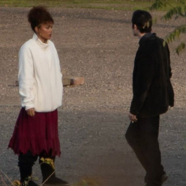 New set images from The Hunger Games: Sunrise on the Reaping reveal Whitney Peak as Lenore Dove and Scot Greenan as Burdock Everdeen, spotted filming between takes at Landschaftspark in Germany.