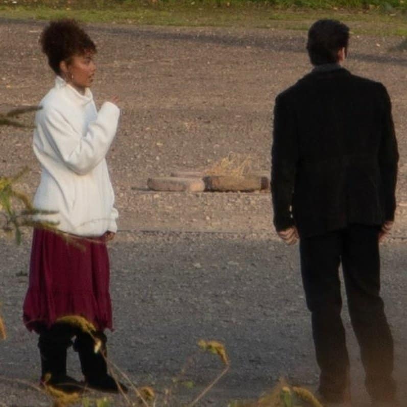 New set images from The Hunger Games: Sunrise on the Reaping reveal Whitney Peak as Lenore Dove and Scot Greenan as Burdock Everdeen, spotted filming between takes at Landschaftspark in Germany.