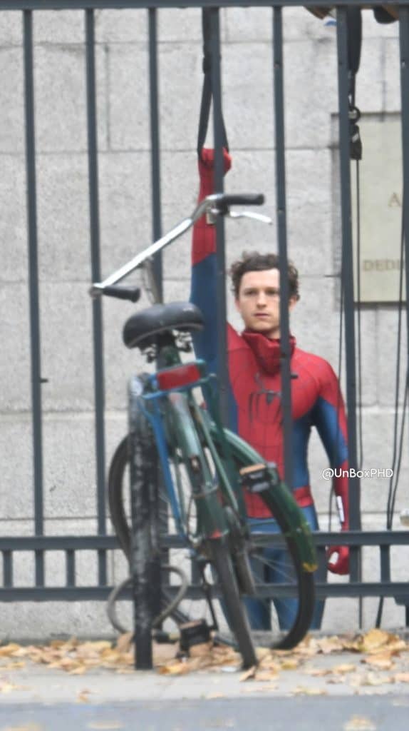See Sadie Sink on the set of Marvel’s Spider-Man: Brand New Day with Tom Holland in London. She wears military-style boots and yellow pants, while director Destin Daniel Cretton is nearby.