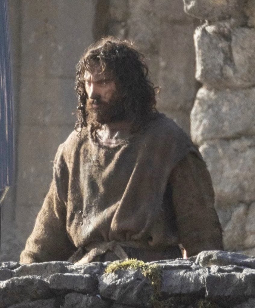 The first look at Robert Eggers’ Werwulf shows Dafoe, Ineson, and Taylor-Johnson in rugged medieval costumes on a muddy set in Bourne Wood, England.