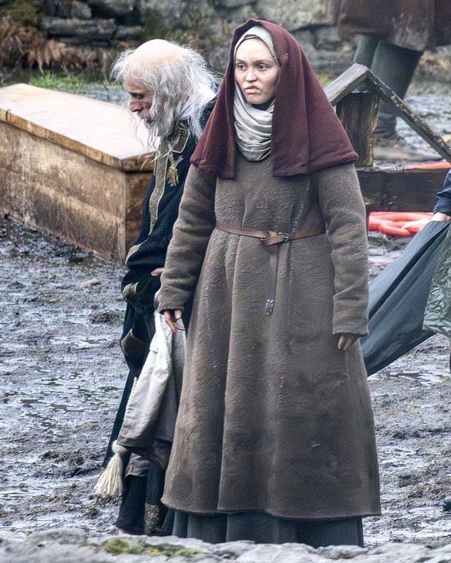 The first look at Lily-Rose Depp on the set of Robert Eggers’ Werwulf in Bourne Wood, England. Depp appears nearly unrecognizable in a gritty, medieval-inspired costume that reflects the film’s dark historical tone.