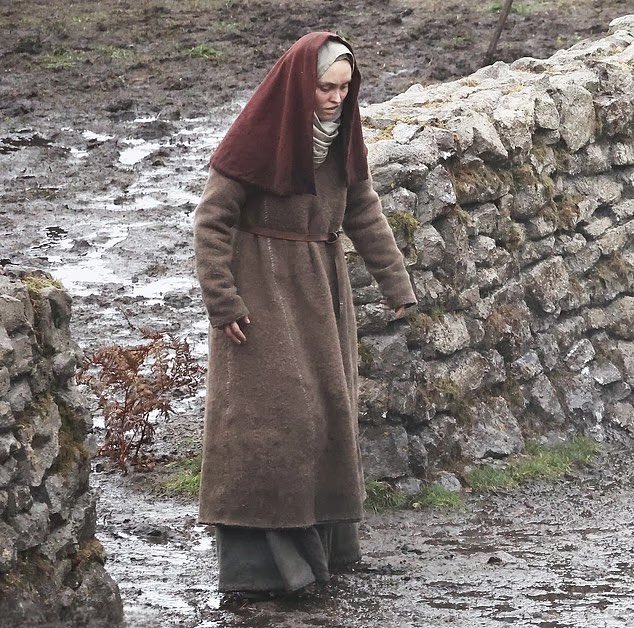 The first look at Lily-Rose Depp on the set of Robert Eggers’ Werwulf in Bourne Wood, England. Depp appears nearly unrecognizable in a gritty, medieval-inspired costume that reflects the film’s dark historical tone.
