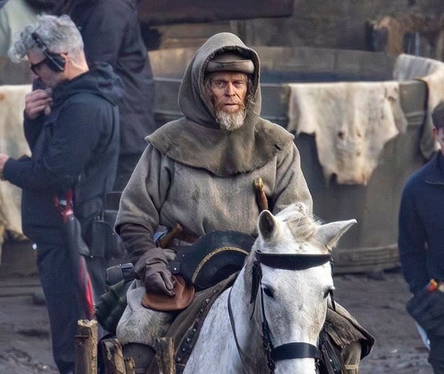 The first look at Robert Eggers’ Werwulf shows Dafoe, Ineson, and Taylor-Johnson in rugged medieval costumes on a muddy set in Bourne Wood, England.