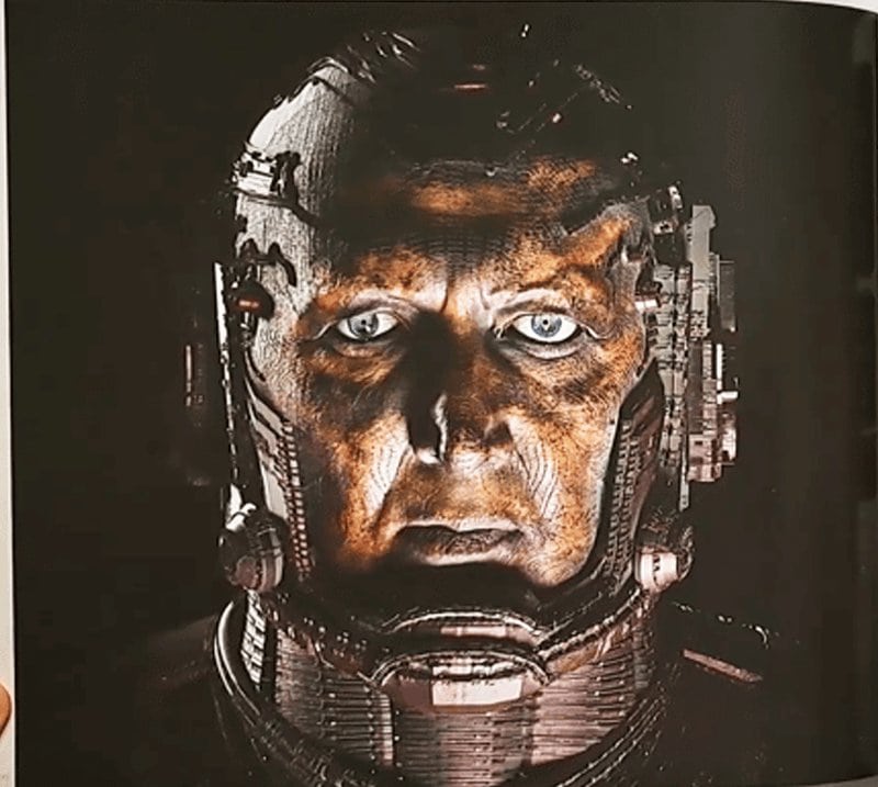 Marvel Studios’ The Fantastic Four: First Steps – The Art of the Movie reveals Ralph Ineson’s Galactus without his iconic helmet, showcasing a human-like face fused into a massive mechanical exoskeleton with intricate cosmic machinery.