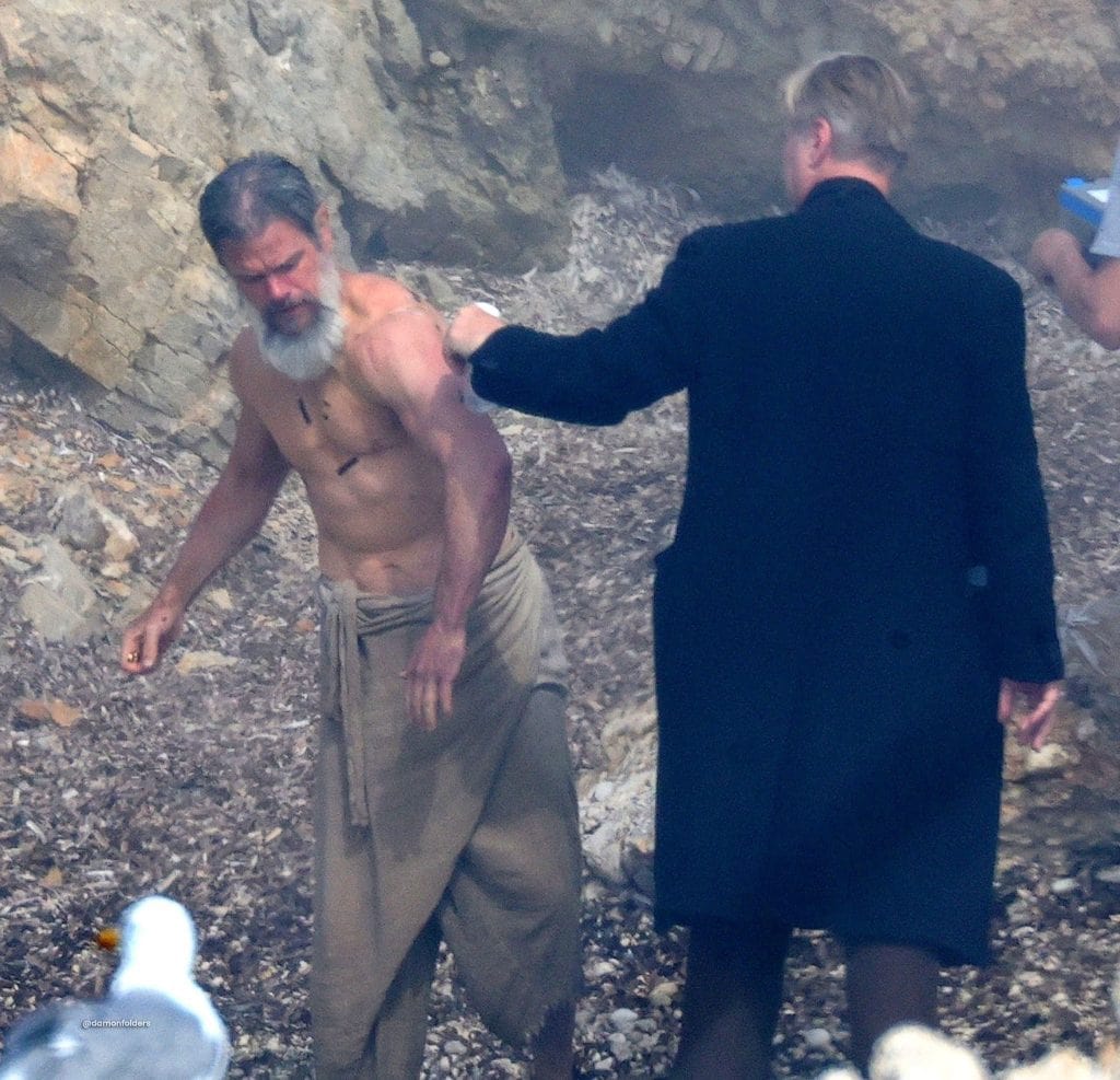 Matt Damon undergoes a dramatic physical transformation for Christopher Nolan’s The Odyssey. New set photos from Favignana Island, Italy, show Damon with a long white beard while filming a major scene with Nolan.