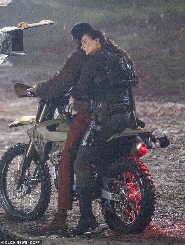 Sophie Turner is spotted filming intense action scenes for Amazon’s Tomb Raider series in Surrey, including a knife fight in heavy rain and a motorcycle escape with Martin Bobb-Semple as Zip.