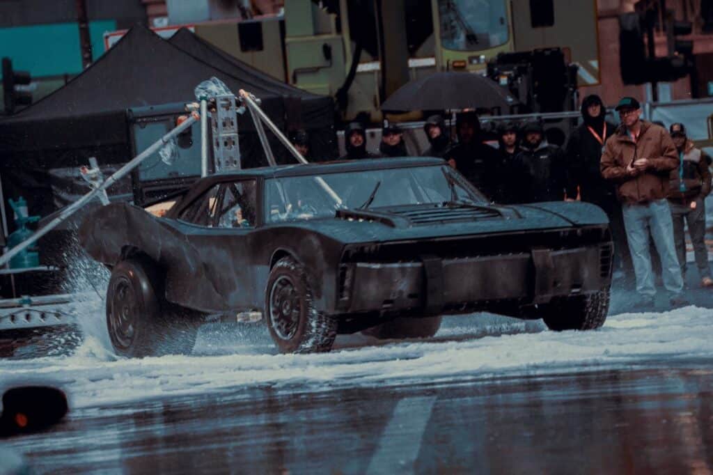 New The Batman: Part II set images and footage show the Batmobile performing stunts in artificial snow during filming in Glasgow.
