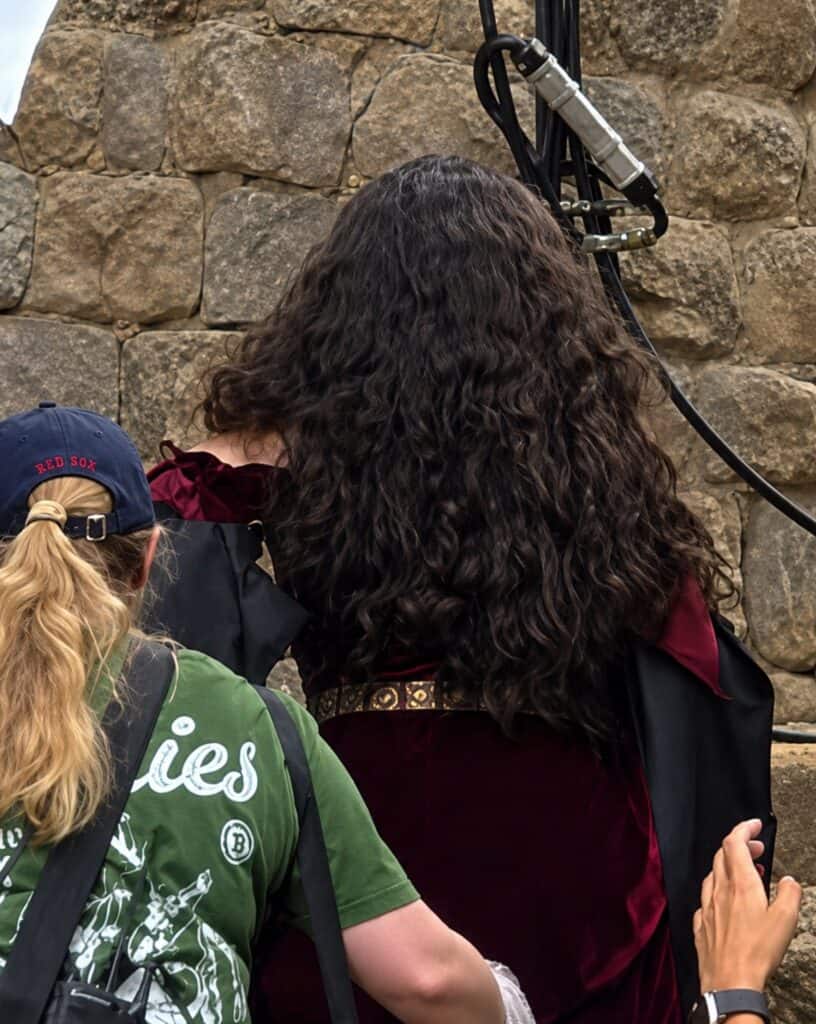 Leaked set photos reveal Kathryn Hahn's first look as Mother Gothel in Disney's live-action Tangled, featuring a costume inspired by the animated classic.