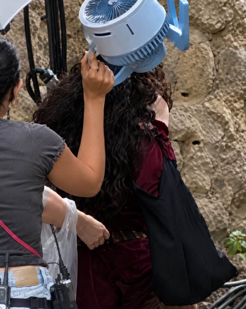 Leaked set photos reveal Kathryn Hahn's first look as Mother Gothel in Disney's live-action Tangled, featuring a costume inspired by the animated classic.